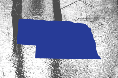 Nebraska state shape on a picture of flooding