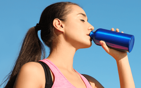 girl drinking from water bottle