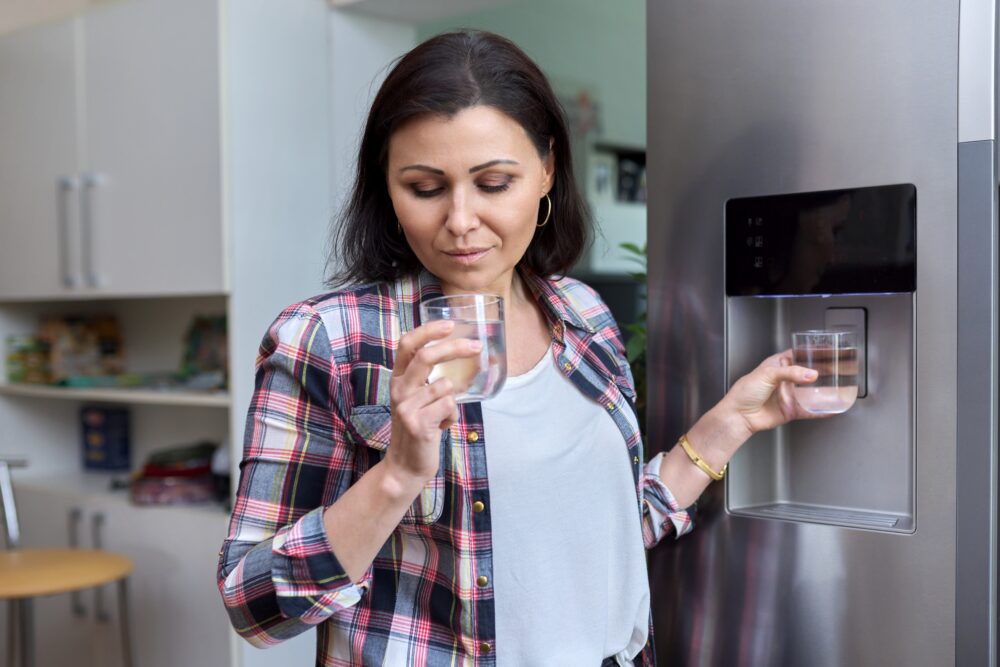 Close-up of water from a refrigerator, highlighting concerns about its effectiveness in removing PFAs from drinking water.