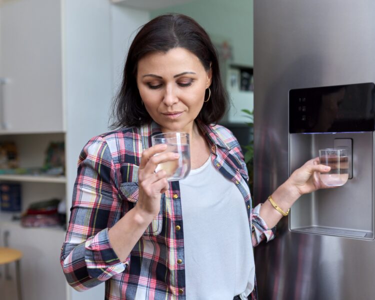 Close-up of water from a refrigerator, highlighting concerns about its effectiveness in removing PFAs from drinking water.