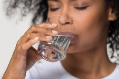 woman drinking distilled water