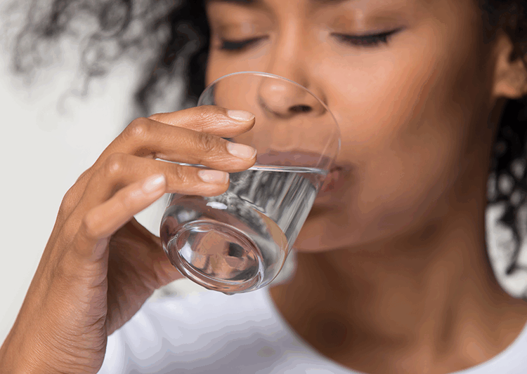 woman drinking distilled water