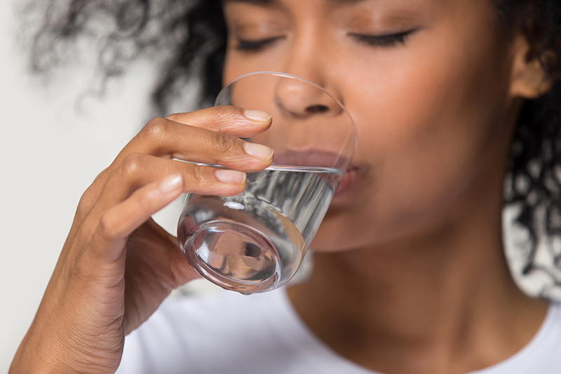 woman drinking distilled water